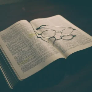Open Bible with reading glasses resting on the pages