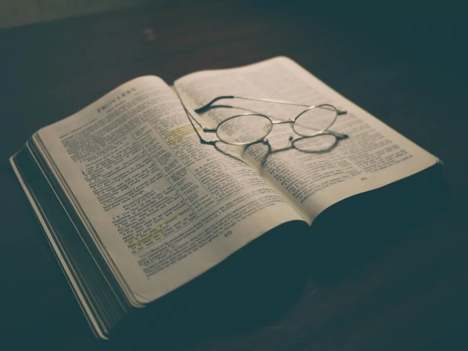 Open Bible with reading glasses resting on the pages